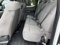 Interior view of a 2018 Ford F-150 showing the rear bench seat with grey fabric upholstery and seat belts