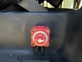 A red control knob with a white indicator dial for a 2017 Chevrolet Express vehicle placed on a dark surface