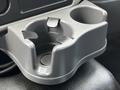 A gray cup holder with two compartments designed for holding beverages inside a 2017 International WorkStar 7600 truck cab