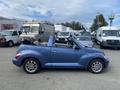 A blue 2007 Chrysler PT Cruiser convertible parked with the top down showing its sleek design and chrome wheels