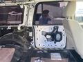 A 2013 Ford Expedition interior showing the side door panel partially removed revealing wires and components inside the door frame