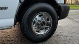 A close-up of a chrome wheel rim and tire on a 2005 Chevrolet Express van