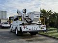 A 2013 International Durastar 4300 bucket truck with an Altec aerial lift attached behind the cab