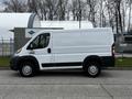 A white 2018 RAM Promaster van is parked with its side facing the viewer showing a simple design and large cargo space
