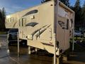 A 2023 Westland 80W 8 Foot truck camper with a sleek design and side graphics mounted on a support frame