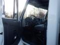 Interior view of a 2014 International Durastar truck showing the steering wheel dashboard and driver's seat visible through the open door