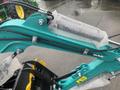 Close-up view of a 2024 AGT Industrial MH12R Mini Excavator arm featuring hydraulic hoses and a bubble-wrapped hydraulic cylinder