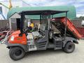 A red and black 2011 Kubota RTV 1140 CPX utility vehicle with an open cargo bed and seating for two passengers in front