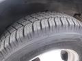 A close-up of a tire from a 2016 Chevrolet Express showing the tread pattern and sidewall details