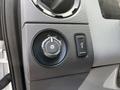 Control panel of a 2016 Ford F-550 featuring a dial for headlight settings and a switch for fog lights