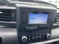 Dashboard display of a 2021 Ford Explorer featuring a digital screen showing radio information and control buttons for volume and tuning