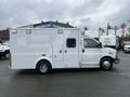 2016 Chevrolet Express van with a white exterior featuring a side door and ambulance-style compartments