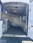 Interior view of a 2014 Ford F-350 SD with metal shelves and a flat floor designed for cargo storage
