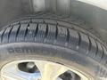 A close-up view of a tire from a 2014 Ford Escape showcasing the tread pattern and the rim design