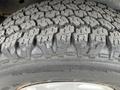 A close-up view of a tire tread from a 2009 Ford Econoline showcasing deep grooves and rugged patterns designed for traction and durability