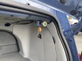 Interior view of a 2007 Chrysler PT Cruiser's trunk showing a light and a switch mounted on the side panel