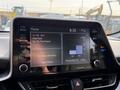 Dashboard of a 2021 Toyota C-HR displaying radio information and navigation options on a touchscreen interface