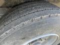 Close-up of a tire from a 2024 Southland 18 Foot Dump Trailer showing tread patterns and wear on the rubber surface
