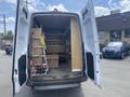 The image shows the back of a 2022 Mercedes-Benz Sprinter van with open doors revealing shelves filled with tools and equipment