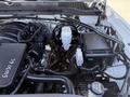 The engine bay of a 2016 GMC Sierra 1500 showcasing various components including the engine, air intake, battery, and fluid reservoirs