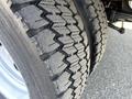 Close-up of a 2008 Ford F-450 SD tire showing tread pattern with visible wear and deep grooves