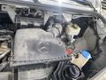 The image shows the engine compartment of a 2024 Mercedes-Benz Sprinter featuring various components such as the air filter housing and fluid reservoirs
