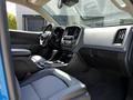 Interior view of a 2021 Chevrolet Colorado showcasing the dashboard center console and seating with a combination of gray and black upholstery