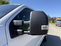 Close-up of the side mirror of a 2017 Ford F-350 SD featuring a black housing and a reflective surface