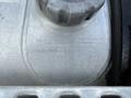 Close-up of a metallic fuel tank with inscription details, including manufacturing date and specifications, attached to a 2012 Volvo VNL truck