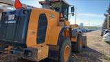 A 2016 Hyundai HL 940 wheel loader with a yellow and black exterior showcasing its large tires and front bucket