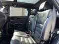 Interior of a 2017 Kia Sorento showing black leather seats with a spacious layout and a panoramic sunroof