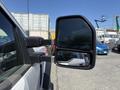 A 2019 Ford F-550 truck mirror with a clear view reflecting the surrounding area