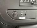 Close-up of the control panel inside a 2008 Chevrolet Express showing buttons for the liftgate and dome lights along with a power outlet