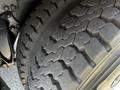 Close-up of a heavily treaded tire on a 2012 Freightliner M2 112 showcasing significant wear and texture of the rubber surface