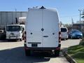 A white 2017 Mercedes-Benz Sprinter van viewed from the rear with a smooth design and large cargo space