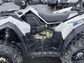 A 2017 Polaris Scrambler ATV featuring a white and black exterior with large tires and visible engine components