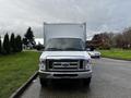 A 2019 Ford Econoline van with a white cargo box in the background