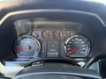 Dashboard of a 2016 GMC Sierra 1500 showing speedometer tachometer fuel gauge and odometer with various warning lights and trip information displayed