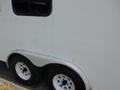 2004 Royal 18 Foot Office Trailer featuring a white exterior with a curved metal skirt and two black wheels with white rims.