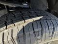 Close-up of a tire from a 2023 Toyota Tundra showing detailed tread patterns and rubber texture