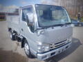 A silver 2008 Isuzu Elf truck with a flatbed cargo area and modern front design featuring headlights and grille