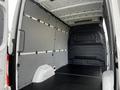 Interior view of a 2022 Mercedes-Benz Sprinter cargo van showing a spacious and empty cargo area with grey and black features