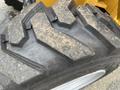 Close-up of a heavy-duty tire from a 2024 AGT Industrial KRW23 Mini Loader featuring a deep tread pattern for traction