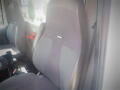 A gray fabric driver's seat of a 2016 International WorkStar 7500 with a simple design and no visible arms