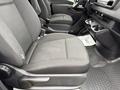 Interior view of a 2019 Mercedes-Benz Sprinter showcasing the driver's seat and console with cup holders