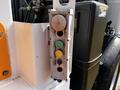 A control panel featuring three colored lights: one green on the bottom, one yellow in the middle, and one red on top attached to a 2010 Peterbilt 320