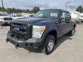 Black 2014 Ford F-250 Super Duty truck with a front grille and a partially visible bumper parked with a clear view of the driver's side