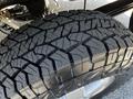 Close-up of a rugged tire with deep treads designed for traction on a 2017 Mercedes-Benz Sprinter vehicle
