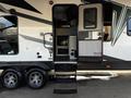 A 2022 Heartland Torque travel trailer with a set of steps leading to the entrance and a door slightly open showcasing the interior space