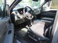 Interior of a 2014 Ford F-150 showing the driver's seat dashboard steering wheel and center console
